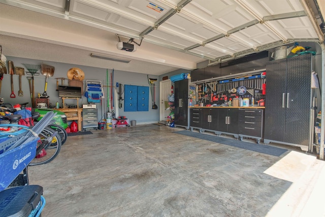 4362 Bridgestone Cir, Bartlett, TN 38135 - garage with a workshop area and a garage door opener