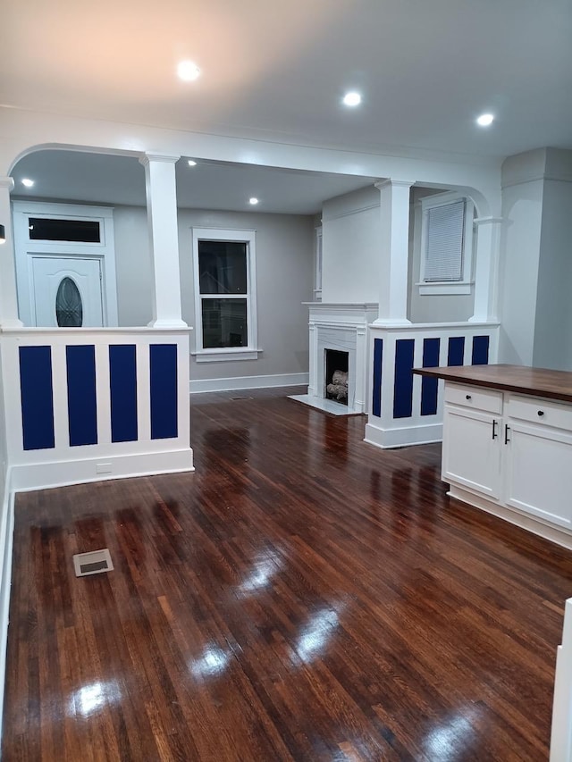 1702 Foster Ave, Memphis, TN 38106 - unfurnished living room with a fireplace with flush hearth, dark wood-style flooring, and recessed lighting