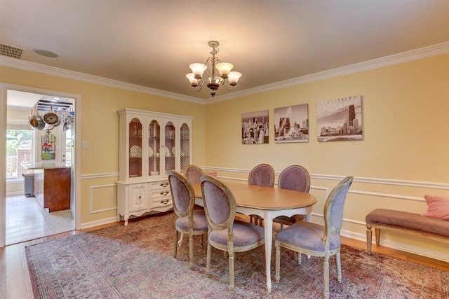 1577 Bubbling Brook Dr, Germantown, TN 38138 - dining area featuring a chandelier, ornamental molding, a decorative wall, and wainscoting
