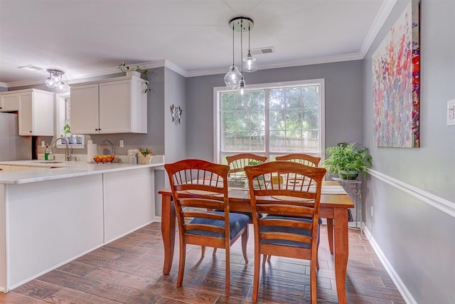 8973 E Carrollwood Ln, Memphis, TN 38016 - dining space featuring dark wood-style flooring and ornamental molding