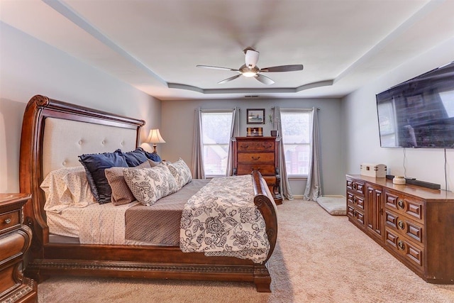 8973 E Carrollwood Ln, Memphis, TN 38016 - bedroom with a tray ceiling, carpet, and a ceiling fan