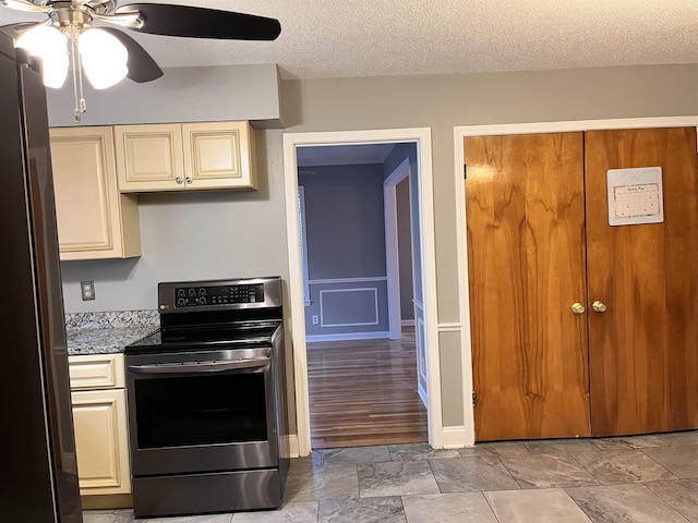 4282 Millbranch Rd, Memphis, TN 38116 - kitchen with stainless steel appliances, cream cabinets, ceiling fan, and a textured ceiling
