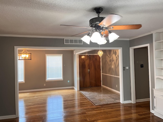 4282 Millbranch Rd, Memphis, TN 38116 - spare room with wood finished floors, a ceiling fan, a textured ceiling, a chandelier, and crown molding