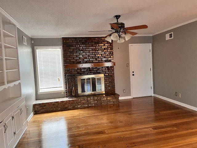 4282 Millbranch Rd, Memphis, TN 38116 - unfurnished living room featuring ceiling fan, wood-type flooring, ornamental molding, and a brick fireplace