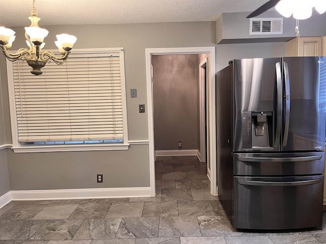4282 Millbranch Rd, Memphis, TN 38116 - kitchen featuring stainless steel fridge with ice dispenser, a chandelier, a textured ceiling, a ceiling fan, and stone finish floors