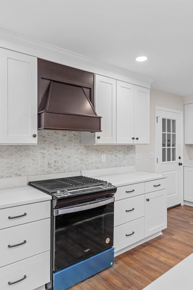 17 County Road 233rd Rd, Corinth, MS 38834 - kitchen featuring stainless steel gas stove, premium range hood, white cabinetry, dark wood finished floors, and tasteful backsplash