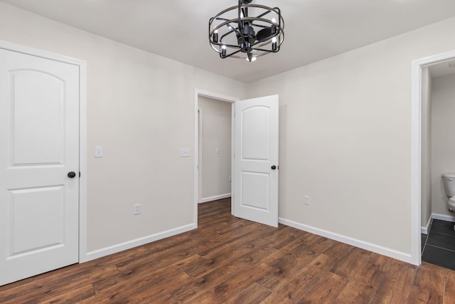17 County Road 233rd Rd, Corinth, MS 38834 - unfurnished bedroom with a chandelier and dark wood-type flooring