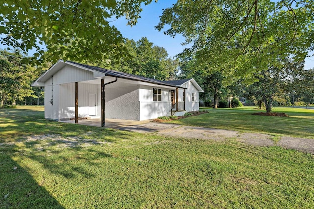17 County Road 233rd Rd, Corinth, MS 38834 - view of side of home featuring a yard, a carport, driveway, and view of scattered trees