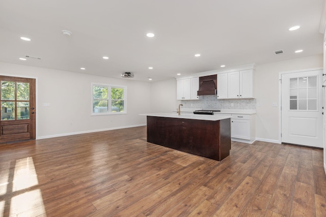 17 County Road 233rd Rd, Corinth, MS 38834 - kitchen featuring light countertops, wood finished floors, custom exhaust hood, backsplash, and white cabinetry
