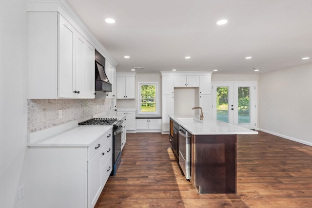 17 County Road 233rd Rd, Corinth, MS 38834 - kitchen featuring range with gas stovetop, wall chimney exhaust hood, plenty of natural light, recessed lighting, and backsplash