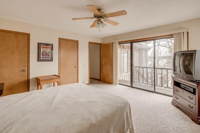 bedroom with light colored carpet, access to exterior, and ceiling fan