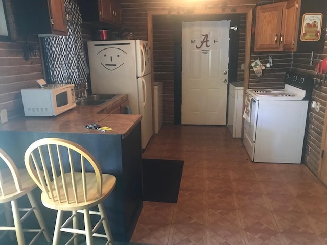 kitchen featuring tasteful backsplash, parquet floors, white appliances, washer / dryer, and sink