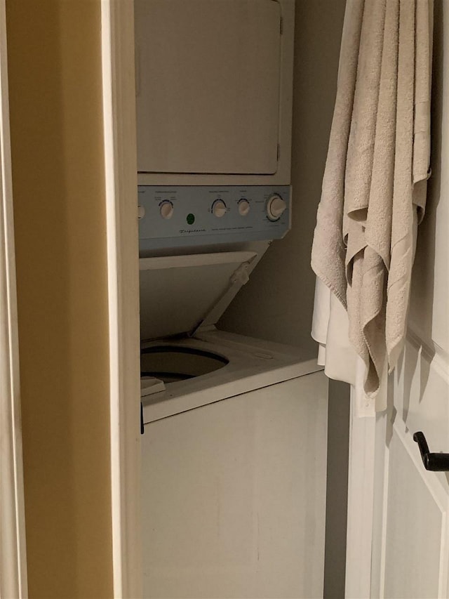 washroom featuring stacked washer and dryer