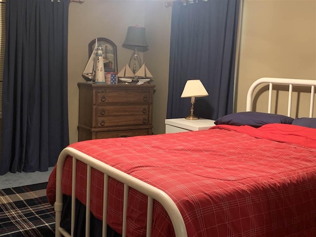 bedroom with dark colored carpet