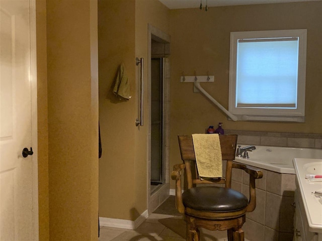 bathroom featuring shower with separate bathtub and tile floors