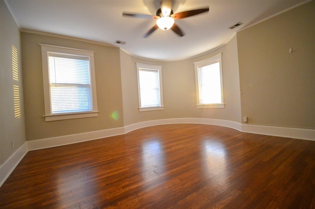 empty room with ornamental molding, dark hardwood / wood-style flooring, and ceiling fan