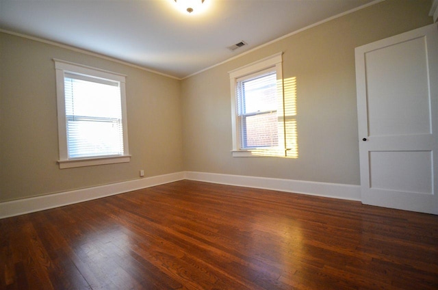 empty room with crown molding and dark wood-type flooring