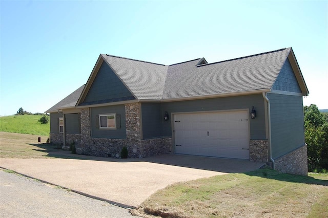 view of front of property with a front yard and a garage