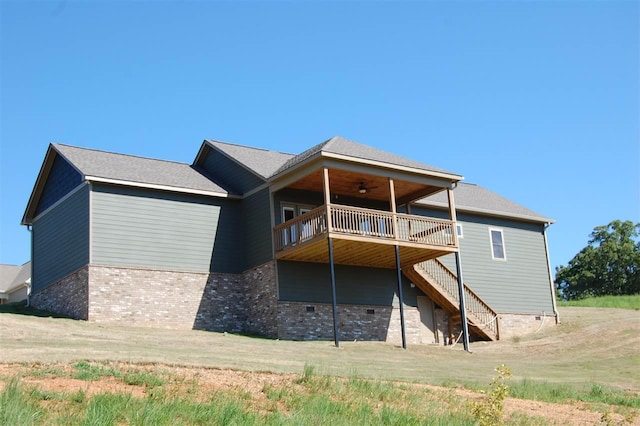 back of house with a deck and ceiling fan