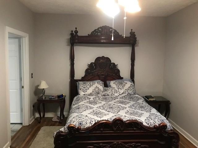 bedroom featuring dark hardwood / wood-style flooring