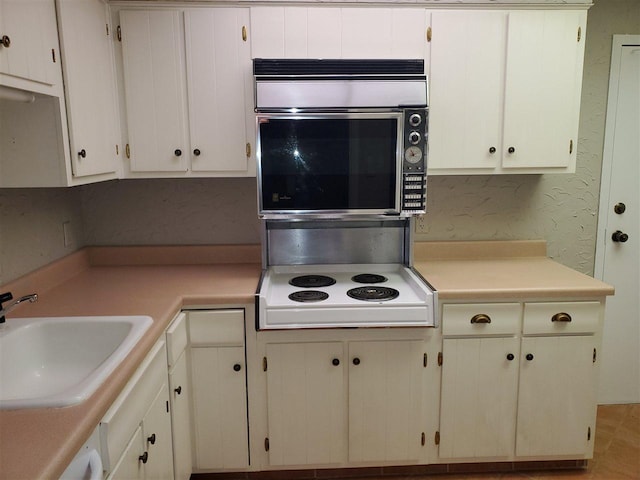 475 N Highland Avenue 3h, Memphis, TN 38122 - kitchen with white cabinets, white electric cooktop, and sink