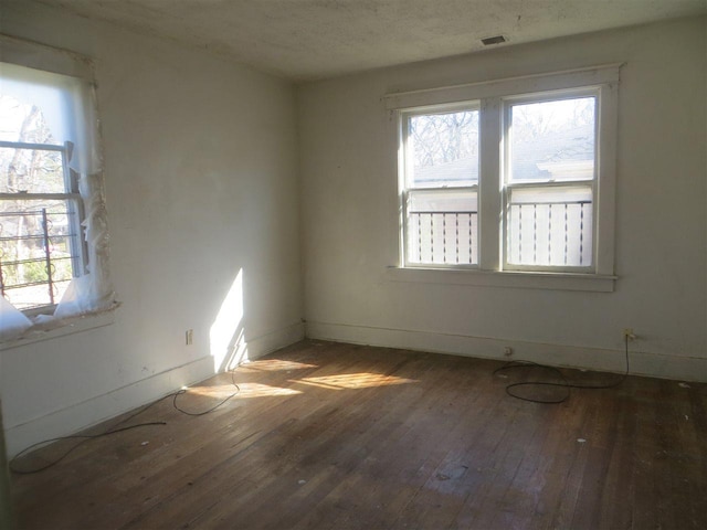 spare room featuring dark hardwood / wood-style flooring