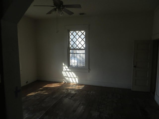 unfurnished room with ceiling fan and dark hardwood / wood-style flooring