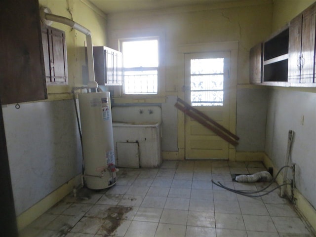 kitchen featuring water heater and light tile flooring