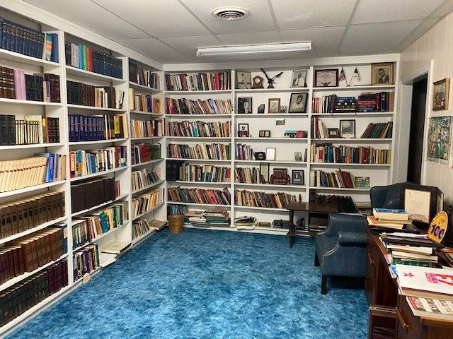 sitting room with dark colored carpet and a drop ceiling