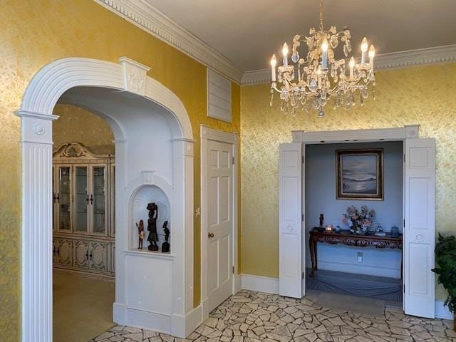 corridor featuring crown molding and an inviting chandelier