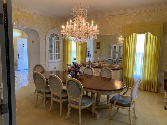 dining area featuring an inviting chandelier and crown molding