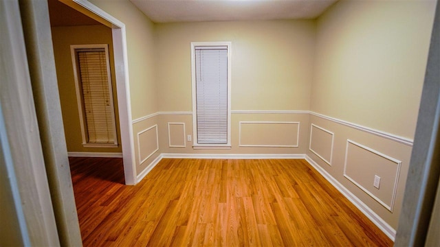 empty room with light hardwood / wood-style flooring