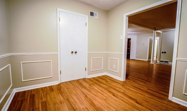 empty room with light hardwood / wood-style flooring