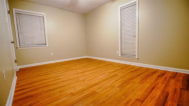 spare room featuring light hardwood / wood-style floors