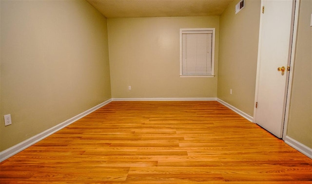 spare room featuring light wood-type flooring