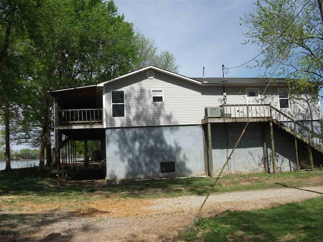 back of house featuring a deck and central air condition unit