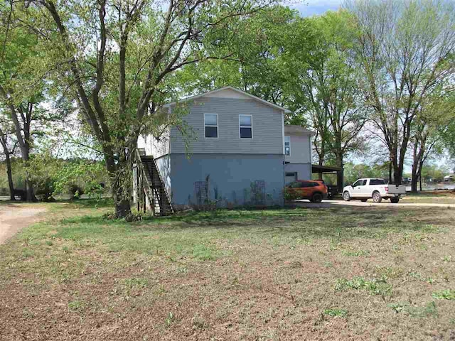 view of side of home with a lawn