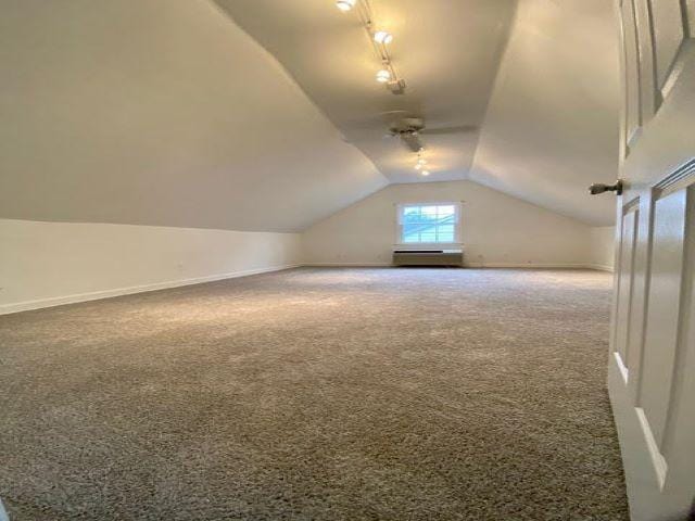 bonus room with carpet flooring and vaulted ceiling