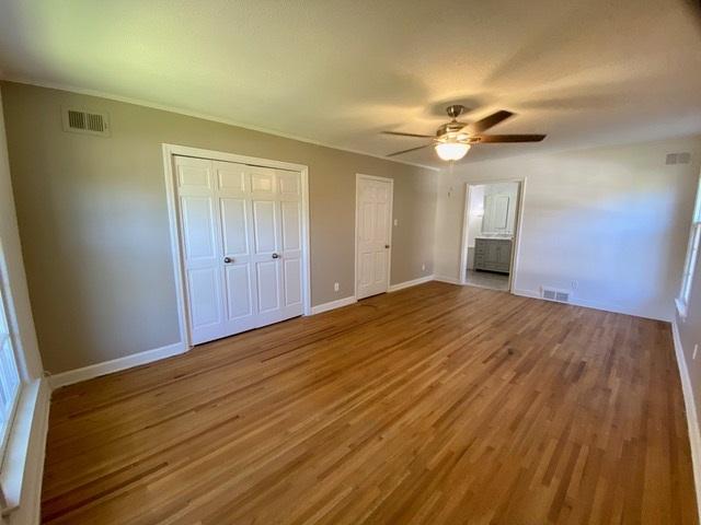 unfurnished bedroom featuring ceiling fan and wood-type flooring