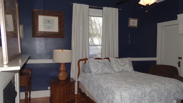 bedroom featuring ceiling fan and dark wood-type flooring