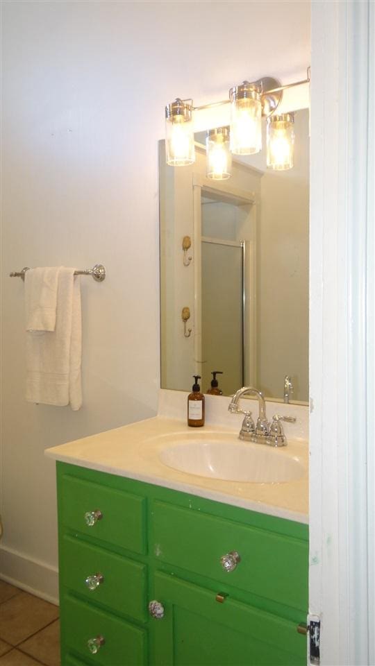 bathroom with tile flooring and vanity