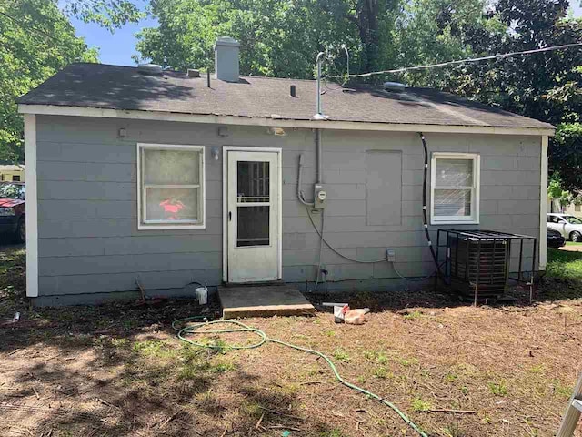 rear view of property featuring central AC unit