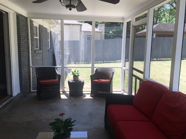 sunroom featuring ceiling fan