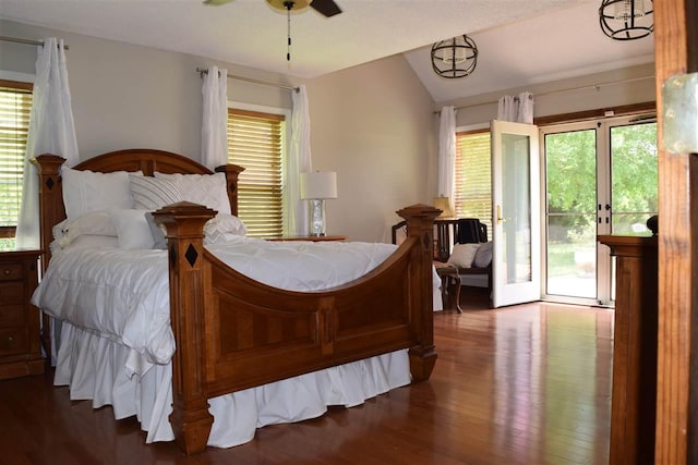 bedroom with access to outside, vaulted ceiling, multiple windows, and dark hardwood / wood-style flooring