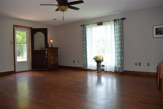 unfurnished living room featuring dark hardwood / wood-style flooring, ceiling fan, and a wealth of natural light