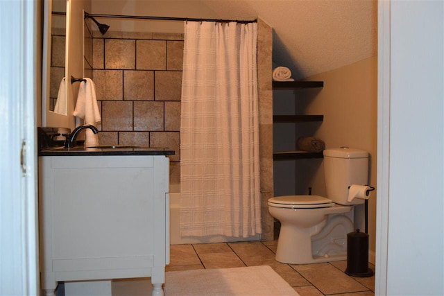 bathroom featuring vanity, tile flooring, a textured ceiling, vaulted ceiling, and toilet