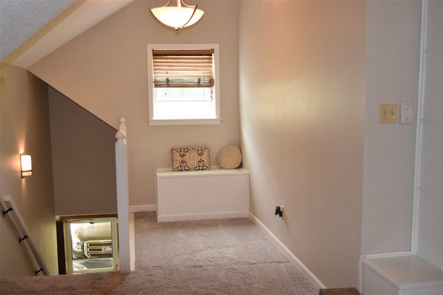 interior space featuring lofted ceiling and light carpet