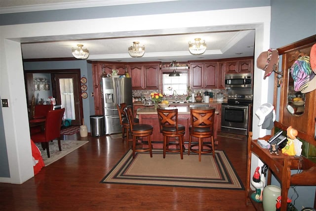 180 Holly Grove Road, Covington, TN 38019 - kitchen with a notable chandelier, appliances with stainless steel finishes, dark hardwood / wood-style flooring, backsplash, and sink