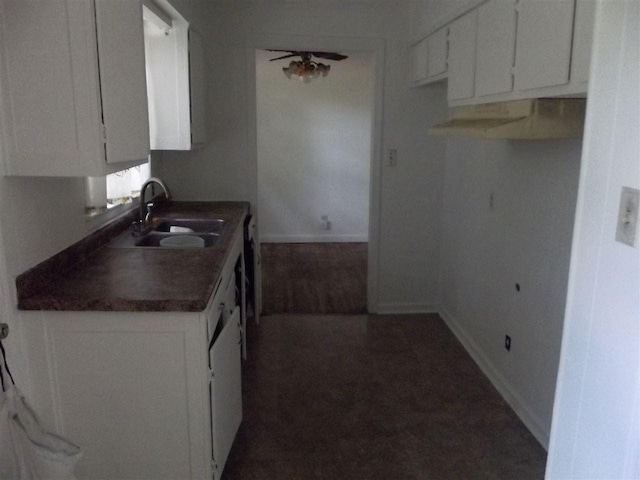 kitchen featuring white cabinets, dark hardwood / wood-style floors, and sink