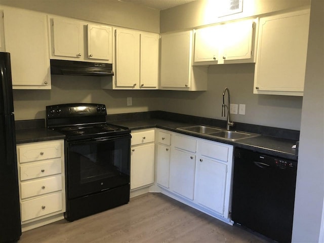 kitchen with white cabinetry, black appliances, light hardwood / wood-style floors, sink, and exhaust hood